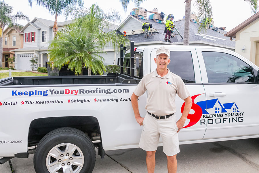 man standing aside of a pick up truck