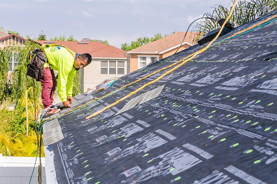 roofer installing asphalt roof